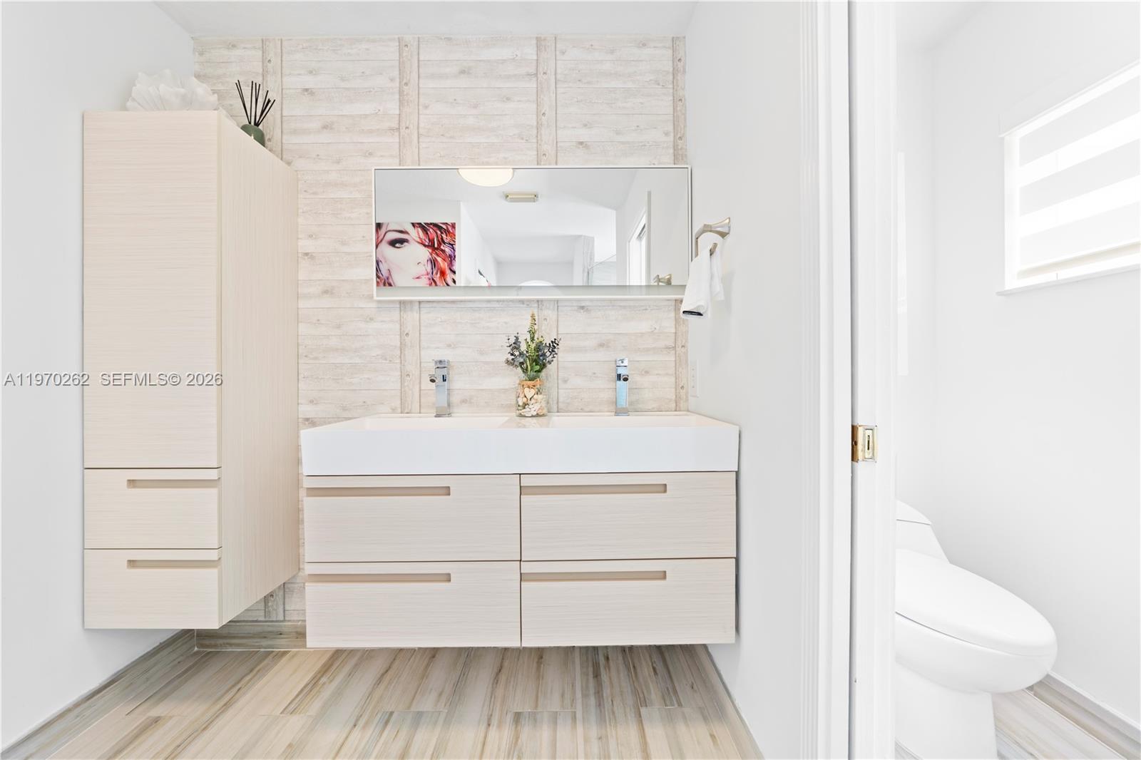 12858 Southwest 50th Street Miramar, FL 33027 - Photo 23 of 36 a bathroom with a sink a toilet and shower