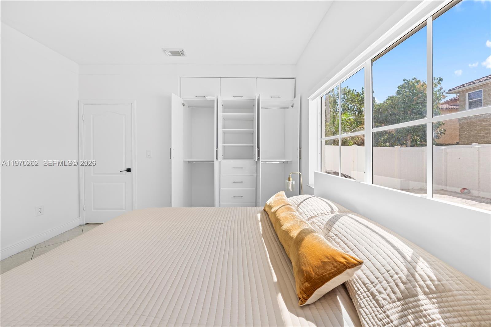 12858 Southwest 50th Street Miramar, FL 33027 - Photo 25 of 36 a bedroom with a bed and a window