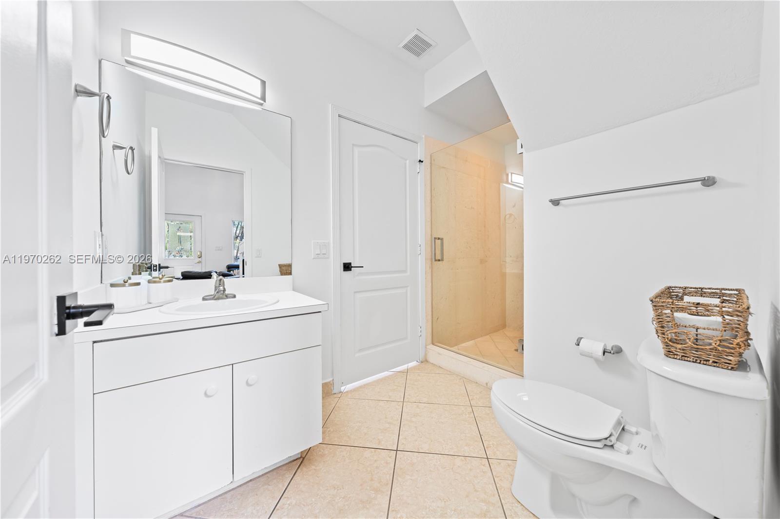 12858 Southwest 50th Street Miramar, FL 33027 - Photo 26 of 36 a bathroom with a sink a toilet and shower