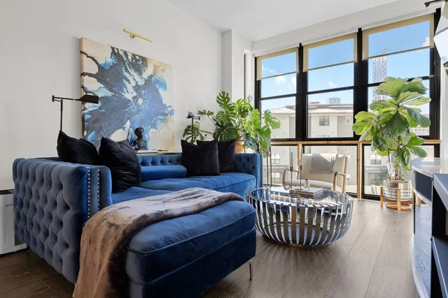 a bedroom with bed and a potted plant