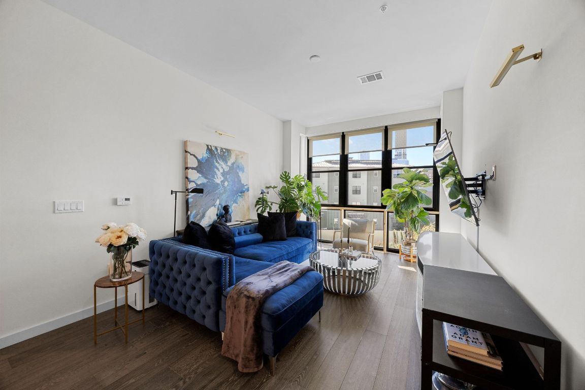 800 Embassy Drive, Unit 229 Austin, TX 78702 - Photo 14 of 40 a living room with furniture and a potted plant