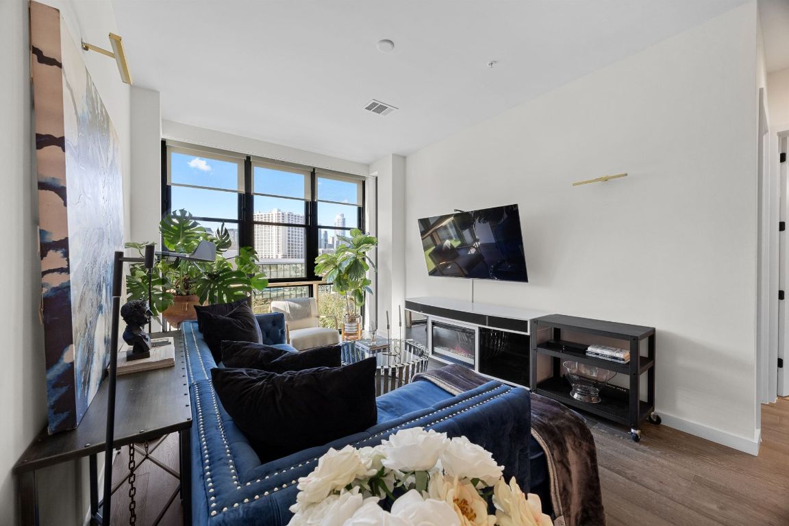 800 Embassy Drive, Unit 229 Austin, TX 78702 - Photo 15 of 40 a living room with furniture and a flat screen tv
