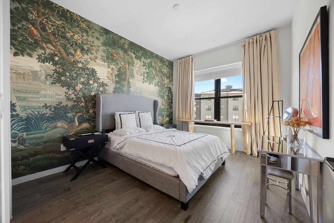 800 Embassy Drive, Unit 229 Austin, TX 78702 - Photo 20 of 40 a bedroom with a bed lamp and a large window