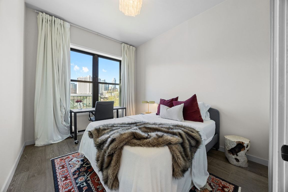 800 Embassy Drive, Unit 229 Austin, TX 78702 - Photo 24 of 40 a bed sitting in a bedroom next to a window