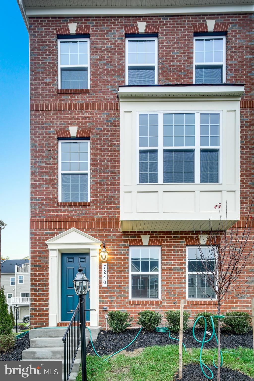7240 Brinley Way Hanover, MD 21076 - Photo 1 of 22 a view of a brick building with a yard