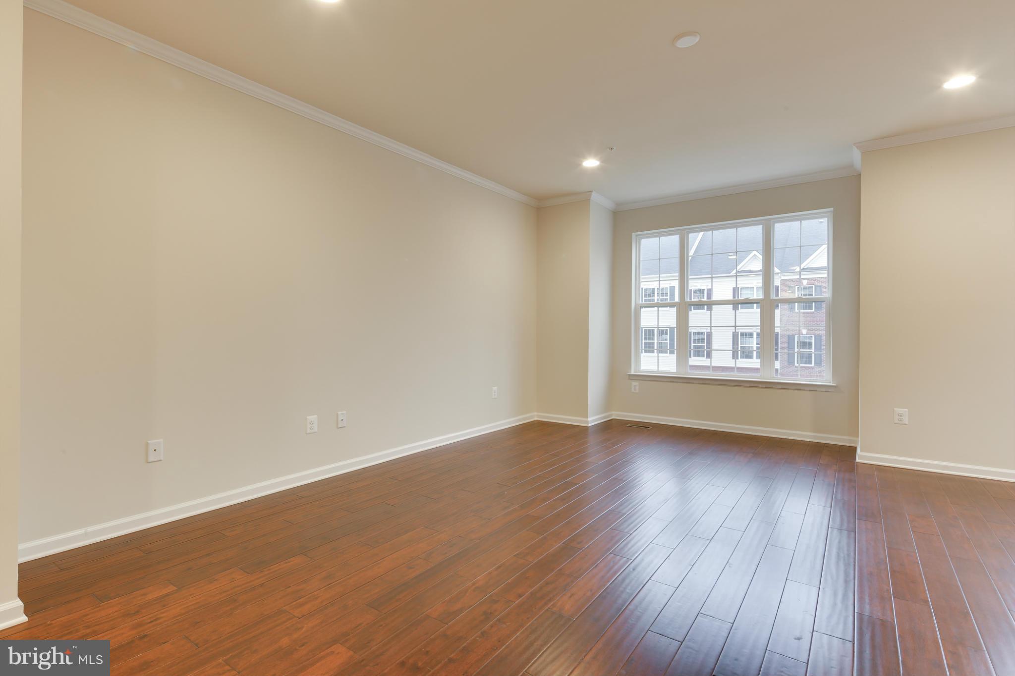7240 Brinley Way Hanover, MD 21076 - Photo 12 of 22 an empty room with wooden floor and windows