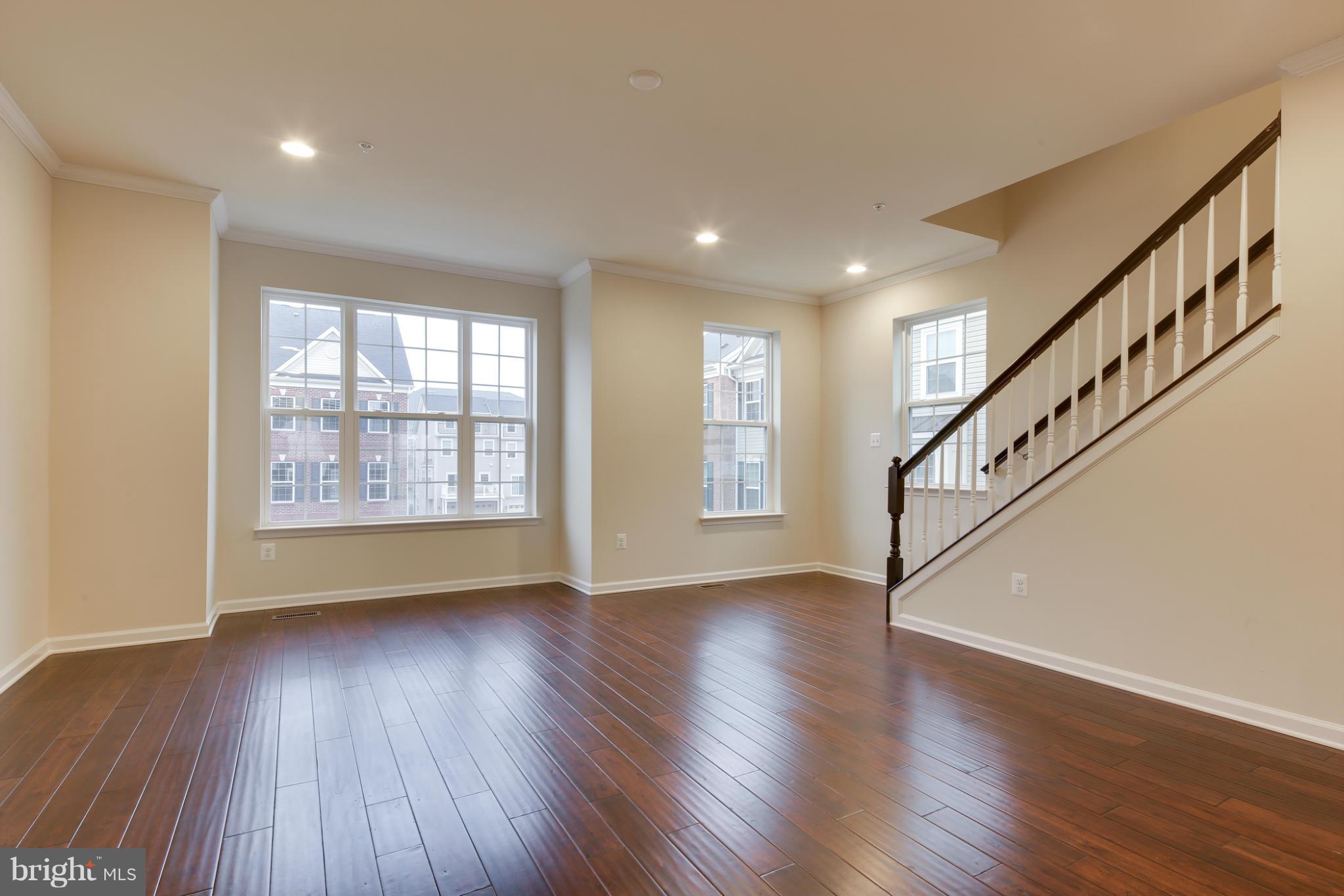 7240 Brinley Way Hanover, MD 21076 - Photo 13 of 22 a view of an empty room with wooden floor and a window