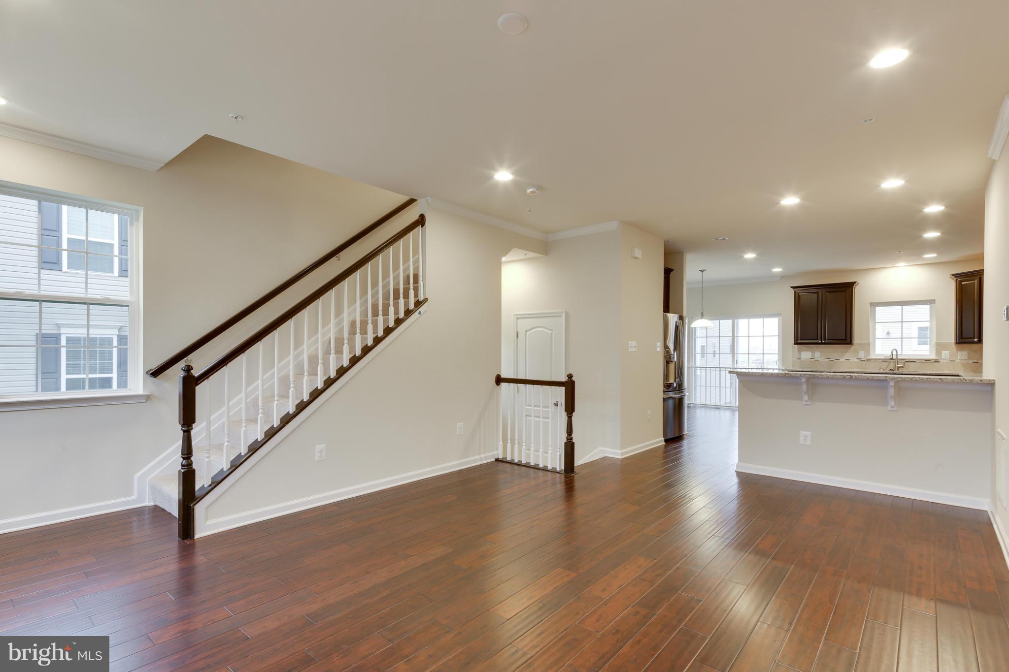 7240 Brinley Way Hanover, MD 21076 - Photo 14 of 22 a view of an empty room with wooden floor