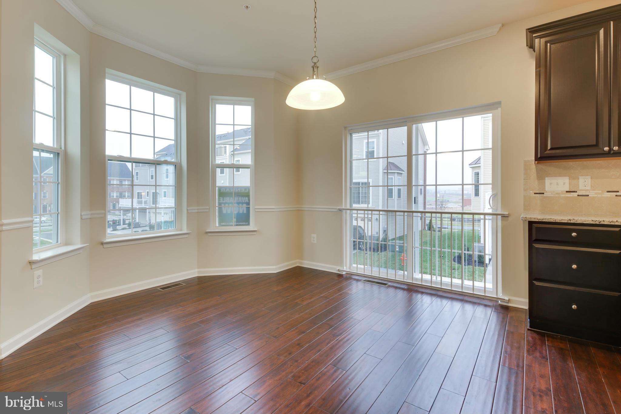 7240 Brinley Way Hanover, MD 21076 - Photo 10 of 22 a view of an empty room with wooden floor and a window