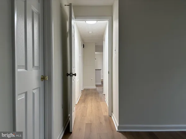a view of a hallway with wooden floor