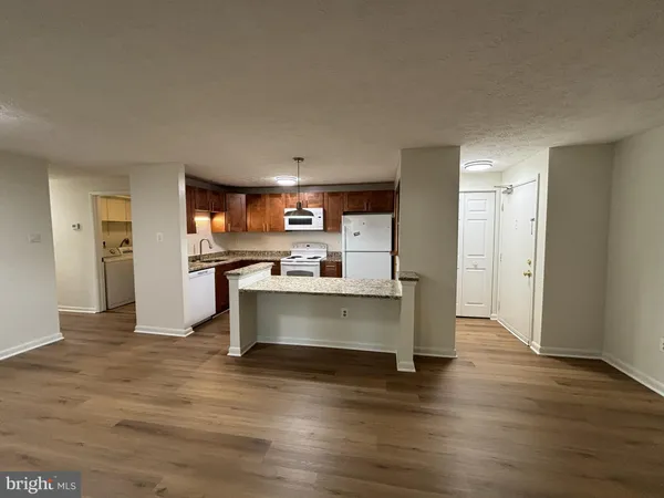 a view of kitchen with refrigerator microwave and cabinets