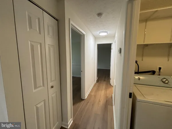 a view of hallway with wooden floor