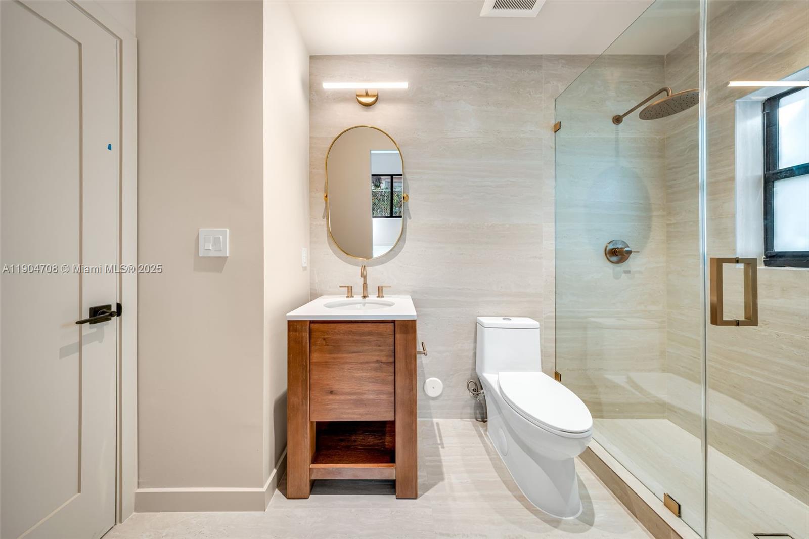 2625 Southwest 32nd Court Miami, FL 33133 - Photo 20 of 23 a bathroom with a toilet a sink and shower