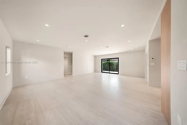 a view of a livingroom with an empty space and a window