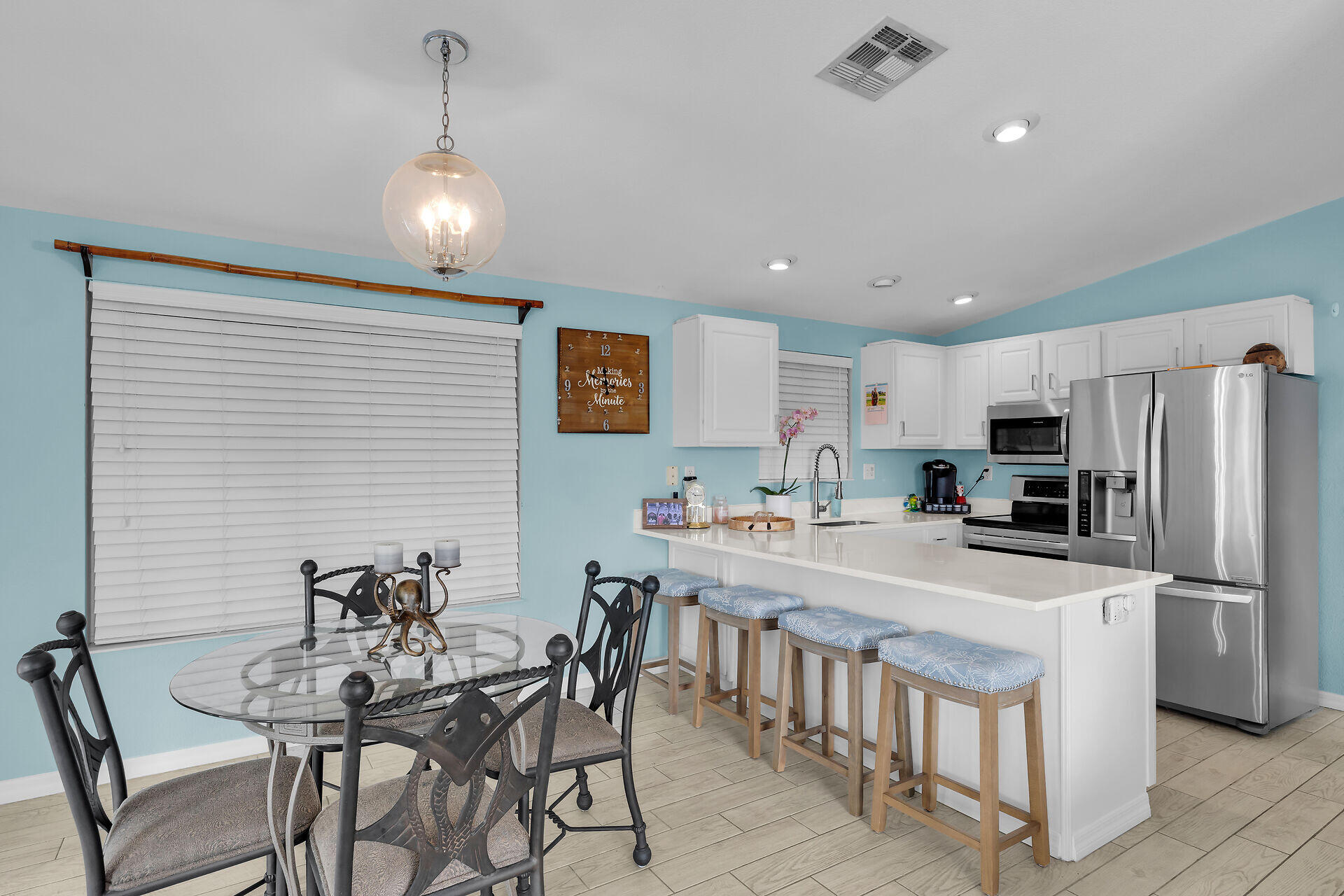 23012 Snapper Lane Cudjoe, FL 33042 - Photo 16 of 45 a kitchen with stainless steel appliances a dining table chairs refrigerator and microwave