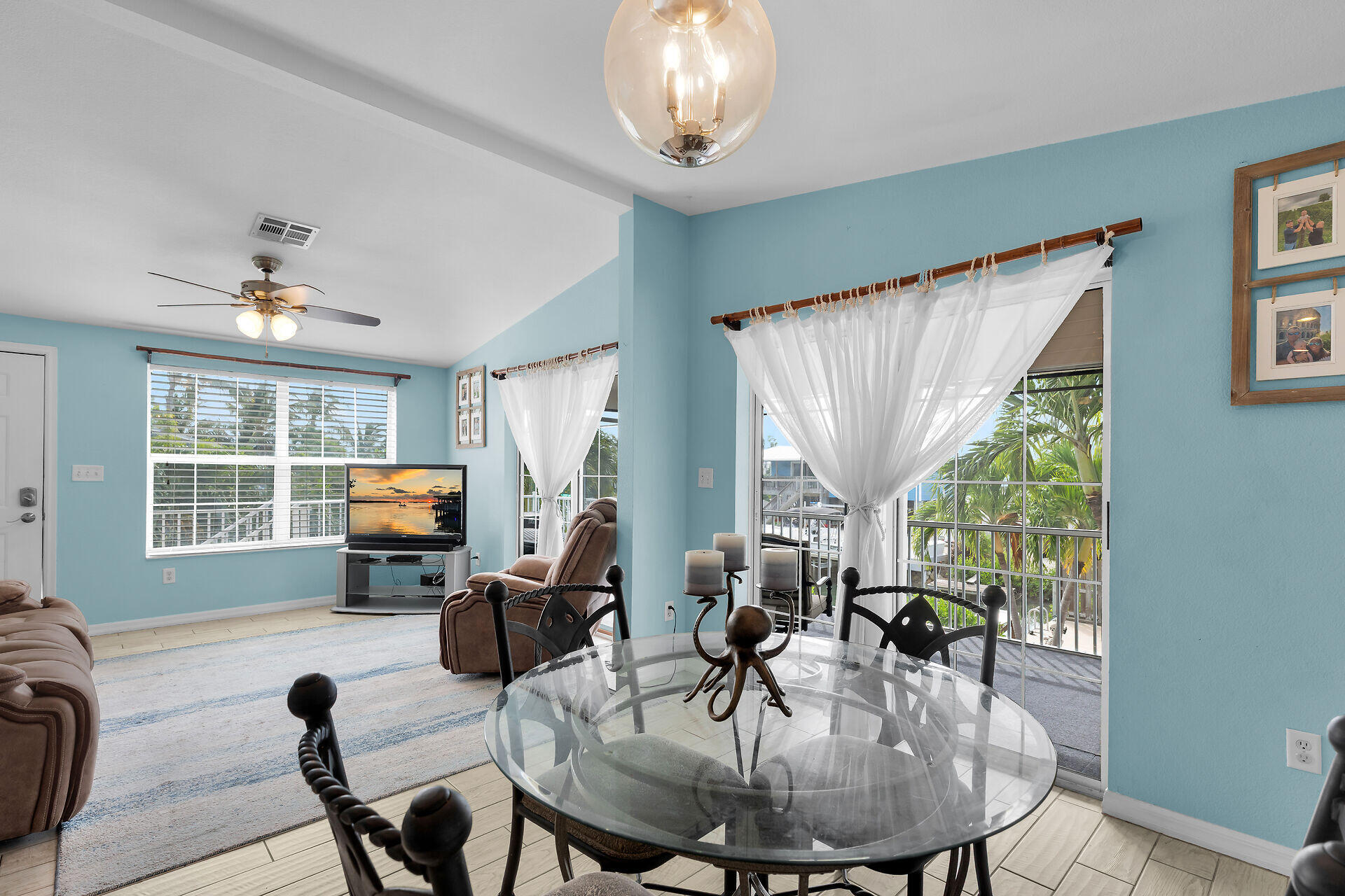 23012 Snapper Lane Cudjoe, FL 33042 - Photo 17 of 45 a view of a dining room with furniture a livingroom and chandelier