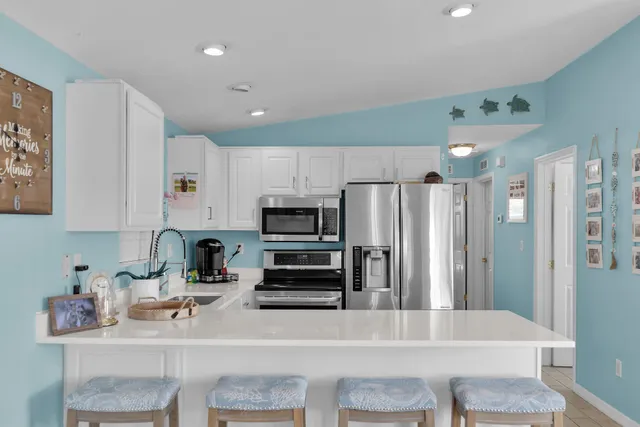 a kitchen with stainless steel appliances a refrigerator and a stove top oven