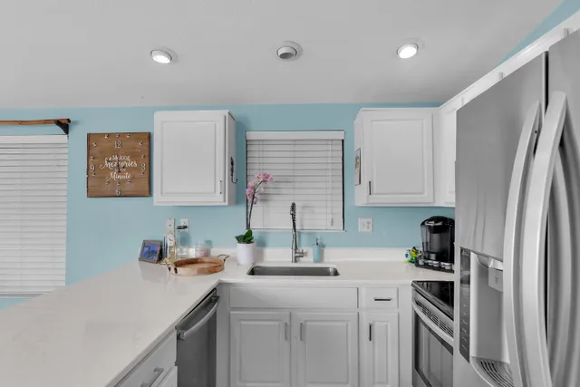 a kitchen with a sink stove and refrigerator