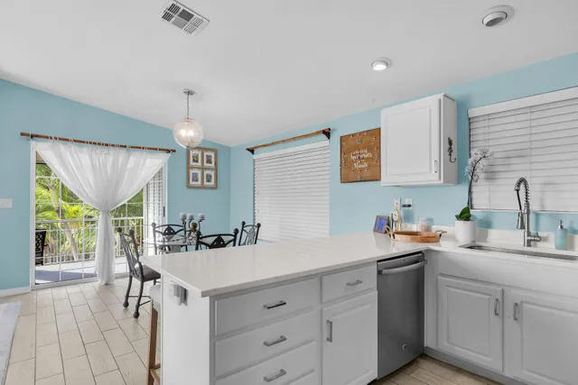 a kitchen with a sink cabinets and window