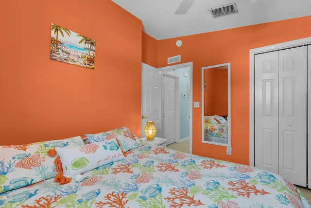 a bedroom with a bed and a painting on the wall