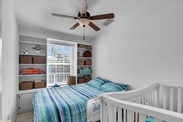 a bedroom with a bed and a bookshelf