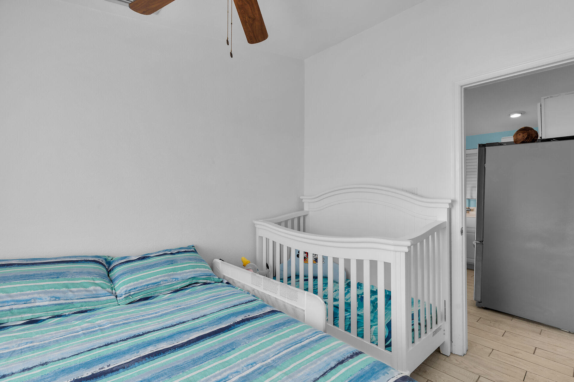 23012 Snapper Lane Cudjoe, FL 33042 - Photo 33 of 45 a bedroom with a bed and wooden floor