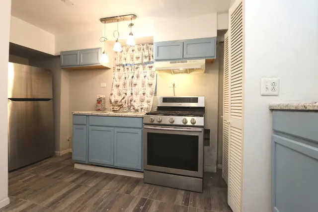 a kitchen with stainless steel appliances a refrigerator and a stove