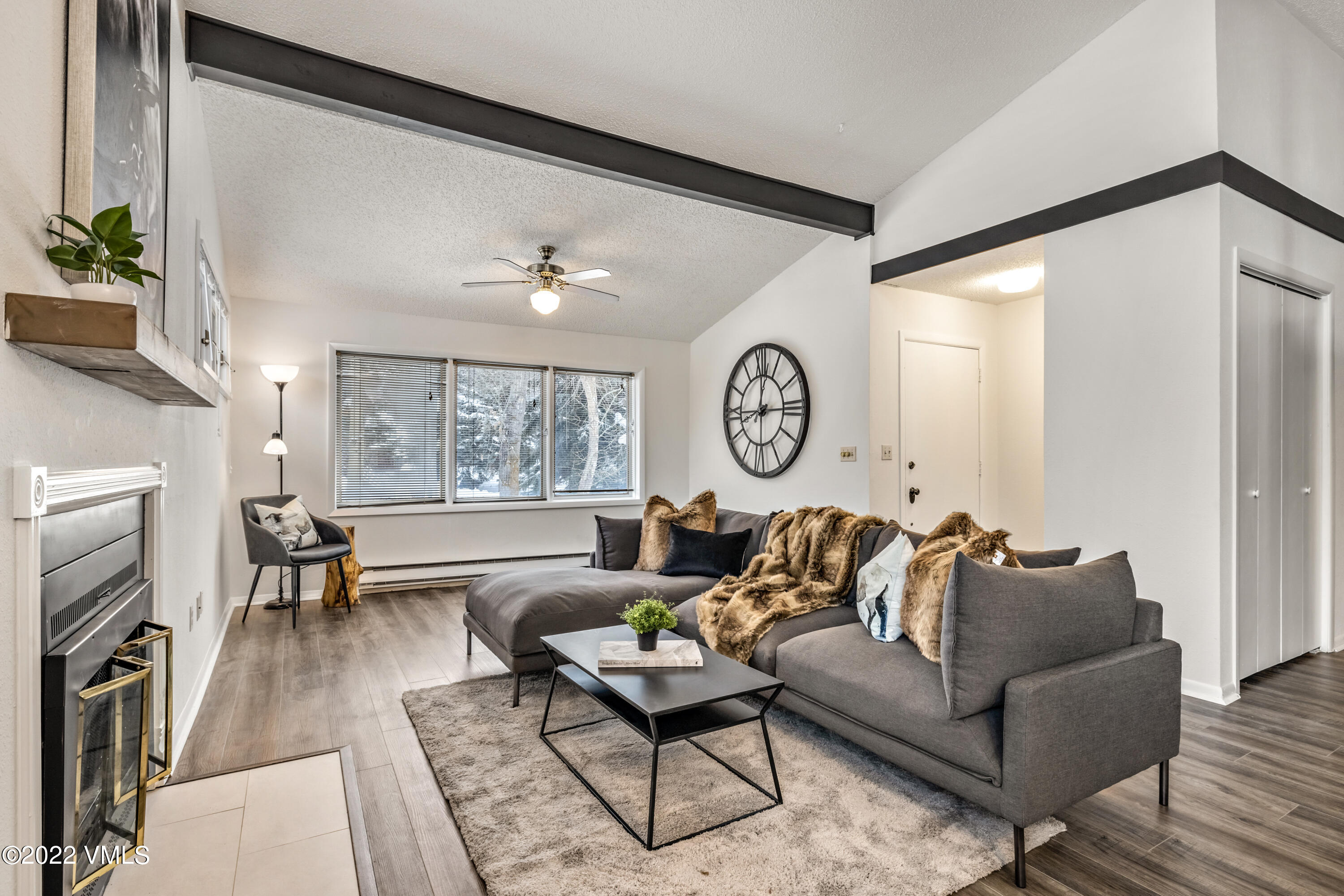 225 Gopher Road, Unit 56 Avon, CO 81620 - Photo 2 of 20 a living room with fireplace furniture and a large window