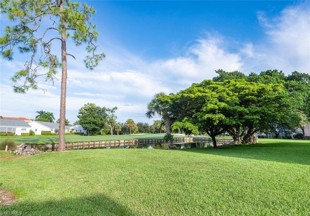 100 Forest Lakes Boulevard, Unit 305 Naples, FL 34105 - Photo 20 of 31 View of yard featuring a water view