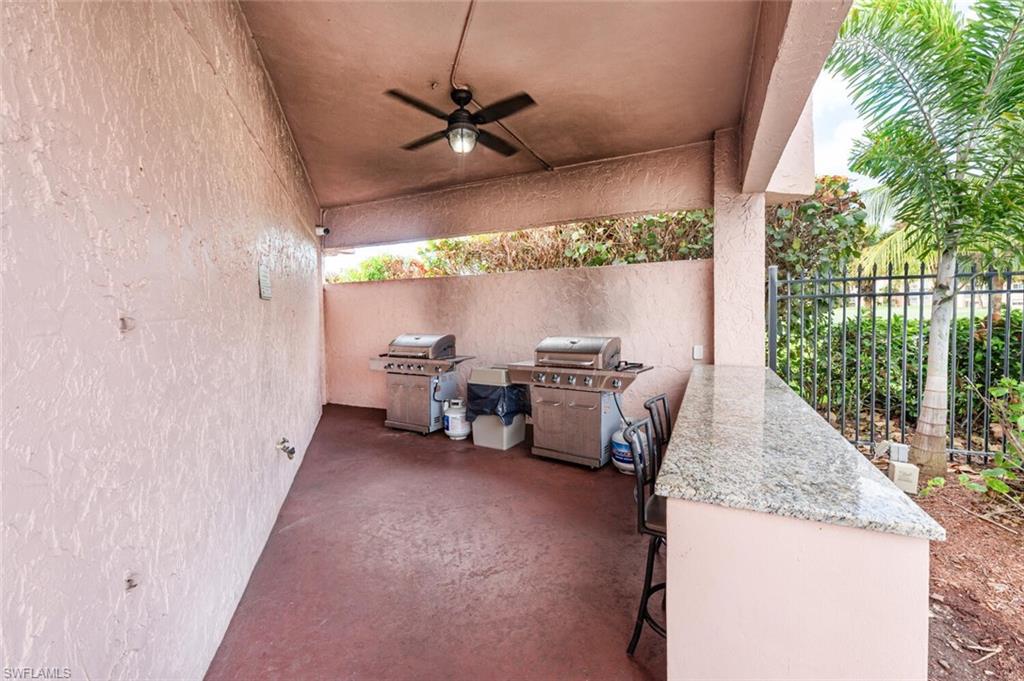 100 Forest Lakes Boulevard, Unit 305 Naples, FL 34105 - Photo 26 of 31 View of patio / terrace with ceiling fan, an outdoor kitchen, and a grill