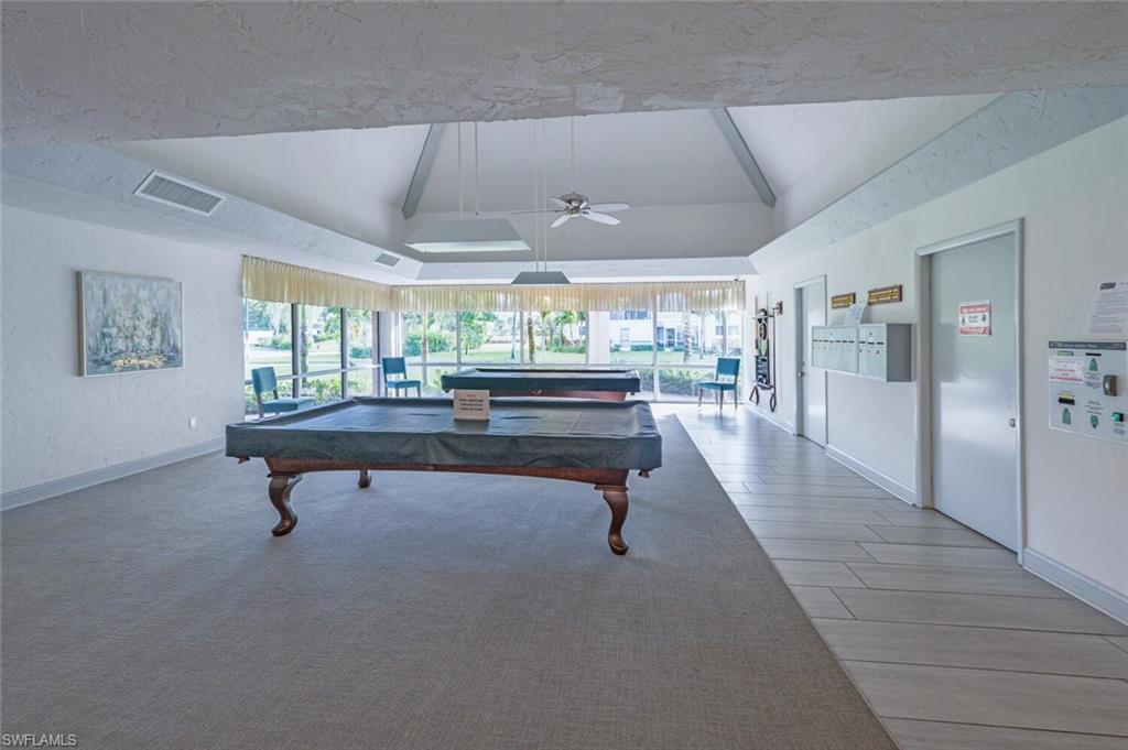 100 Forest Lakes Boulevard, Unit 305 Naples, FL 34105 - Photo 29 of 31 Playroom with vaulted ceiling with beams, wood-type flooring, ceiling fan, and billiards