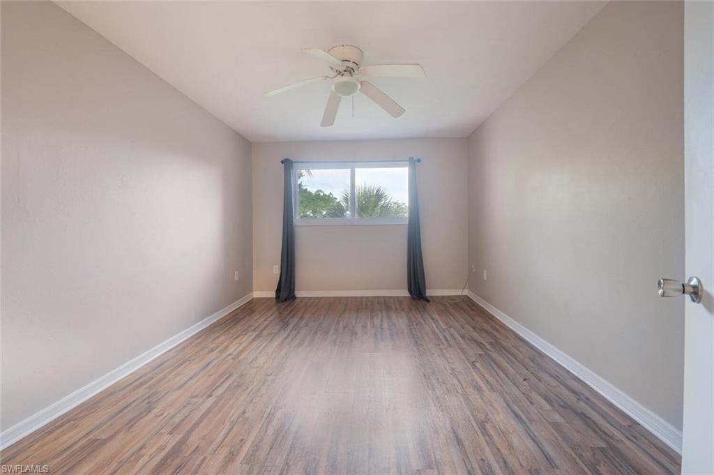 100 Forest Lakes Boulevard, Unit 305 Naples, FL 34105 - Photo 10 of 31 Spare room with ceiling fan and dark hardwood / wood-style flooring