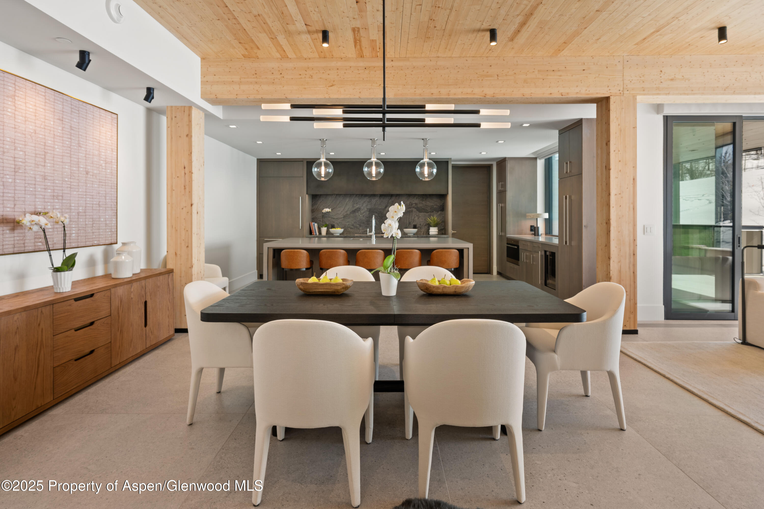 180 Wood Road, Unit 304 Snowmass Village, CO 81615 - Photo 18 of 61 a view of a dining room with furniture and chandelier