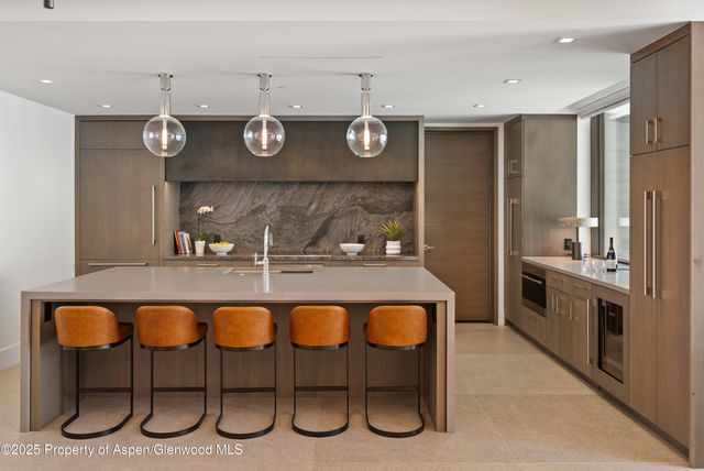 a large white bed sitting in a bedroom next to a window