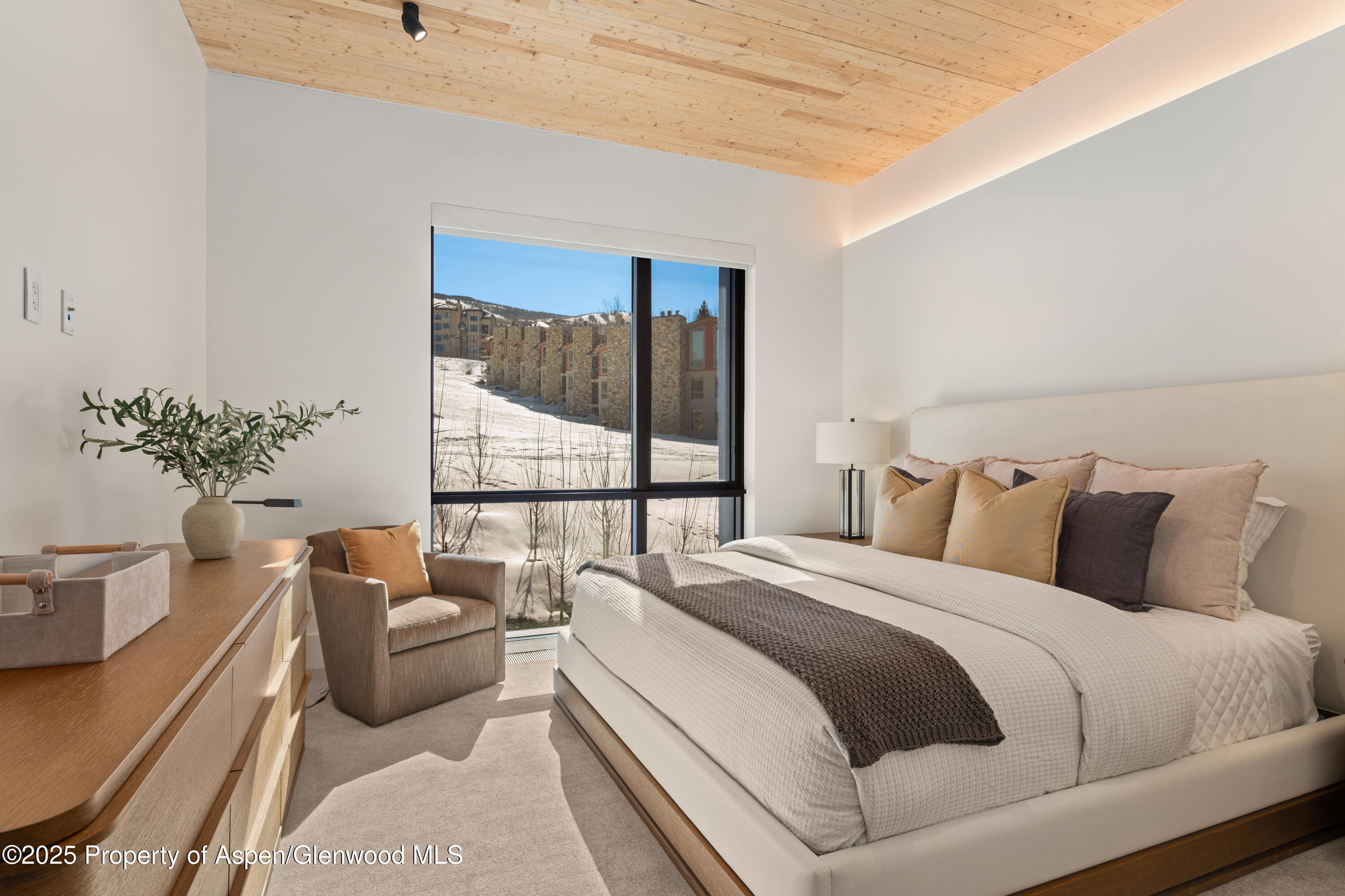 180 Wood Road, Unit 304 Snowmass Village, CO 81615 - Photo 28 of 61 a large white bed sitting in a bedroom next to a window