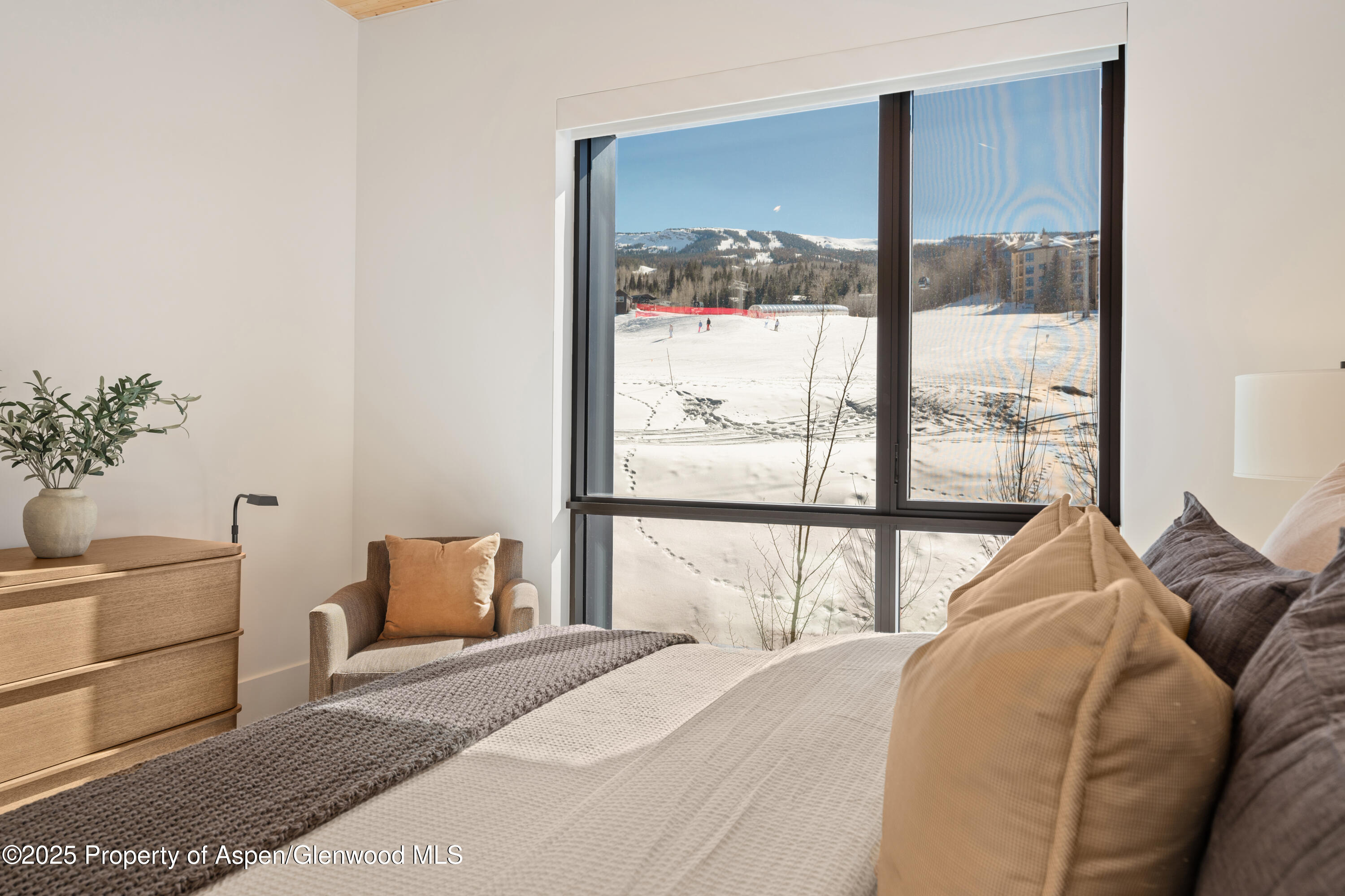 180 Wood Road, Unit 304 Snowmass Village, CO 81615 - Photo 29 of 61 a bedroom with a large bed and a window