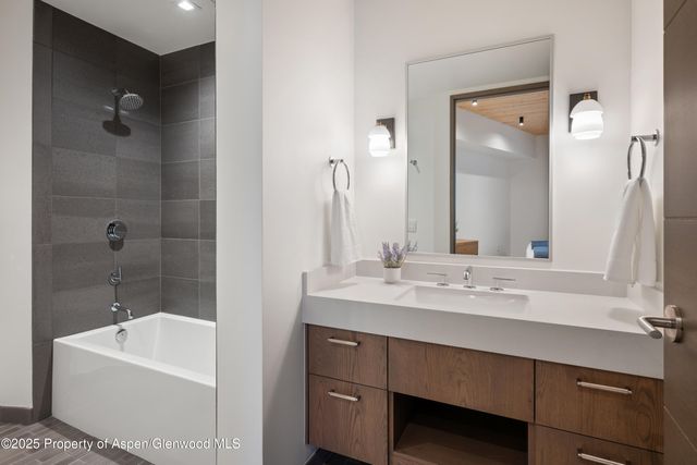 a living room with furniture a mirror and a wooden floor