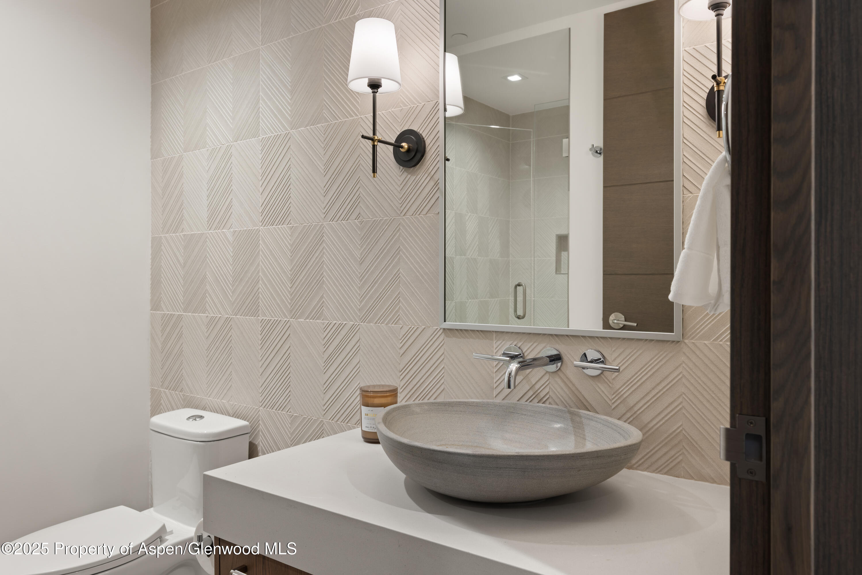 180 Wood Road, Unit 304 Snowmass Village, CO 81615 - Photo 37 of 61 a bathroom with a sink a toilet and a mirror