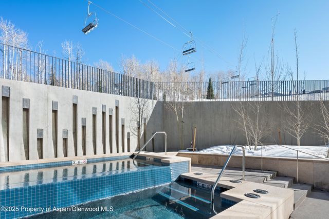 a living room with furniture and a painting on the wall