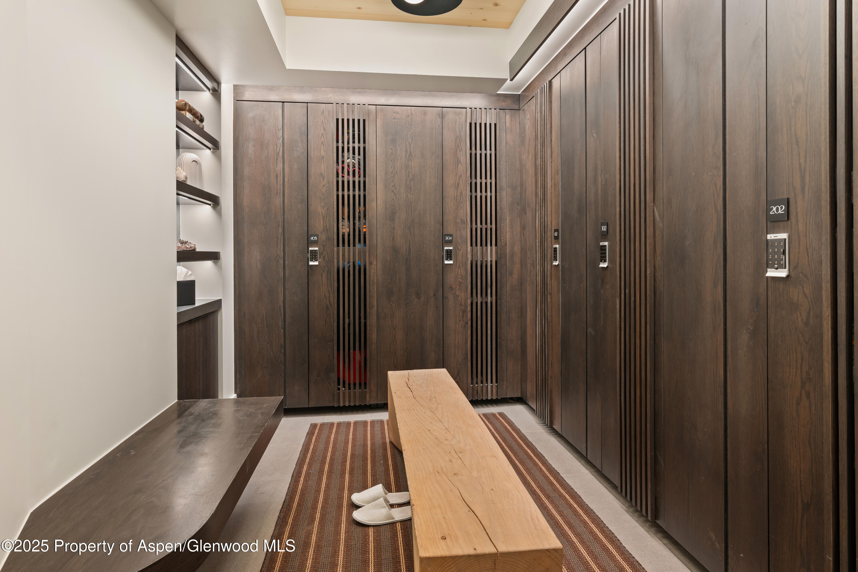 180 Wood Road, Unit 304 Snowmass Village, CO 81615 - Photo 50 of 61 a view of a hallway with wooden floor and staircase