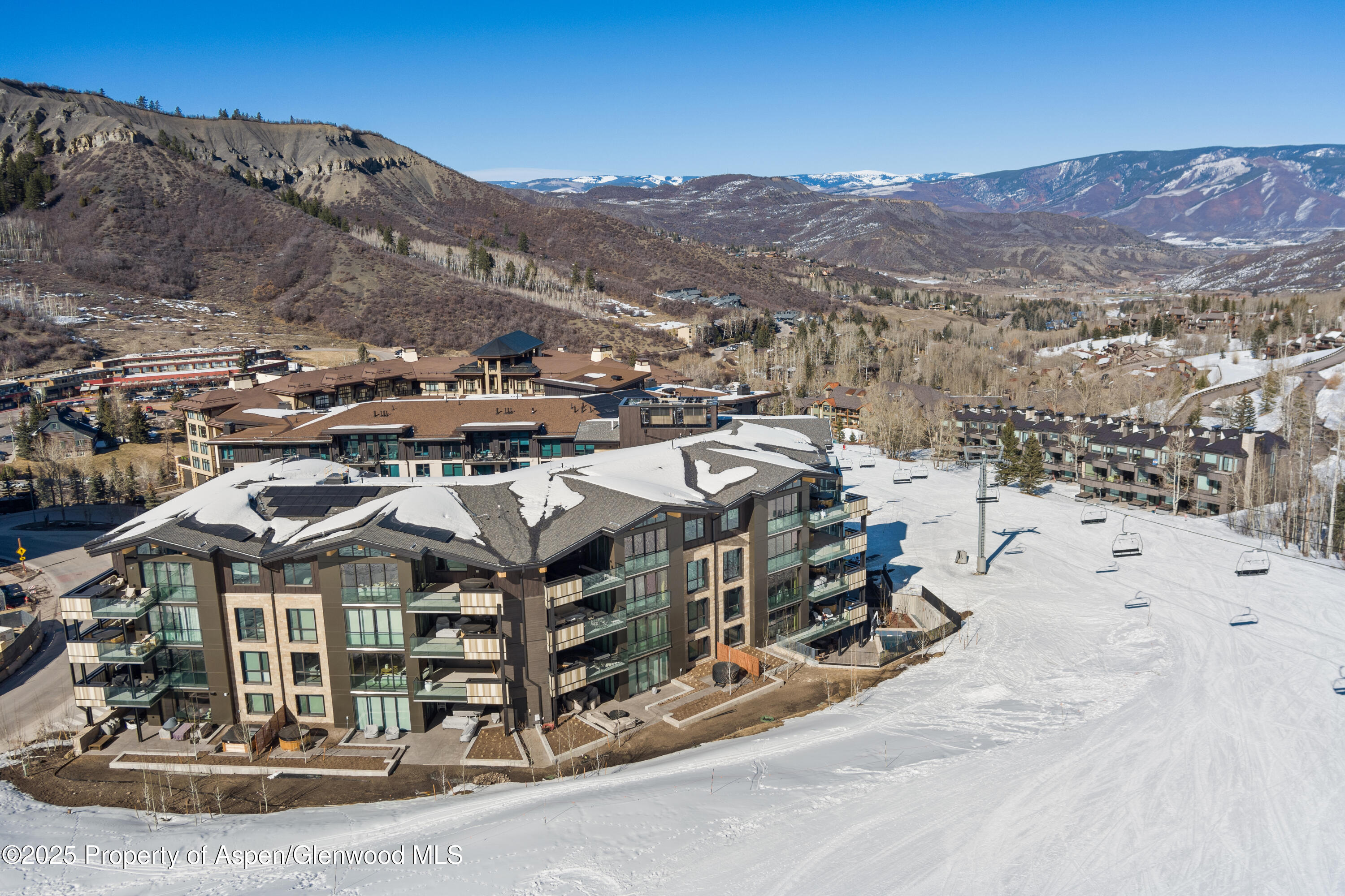 180 Wood Road, Unit 304 Snowmass Village, CO 81615 - Photo 58 of 61 a view of a town with mountains in the background