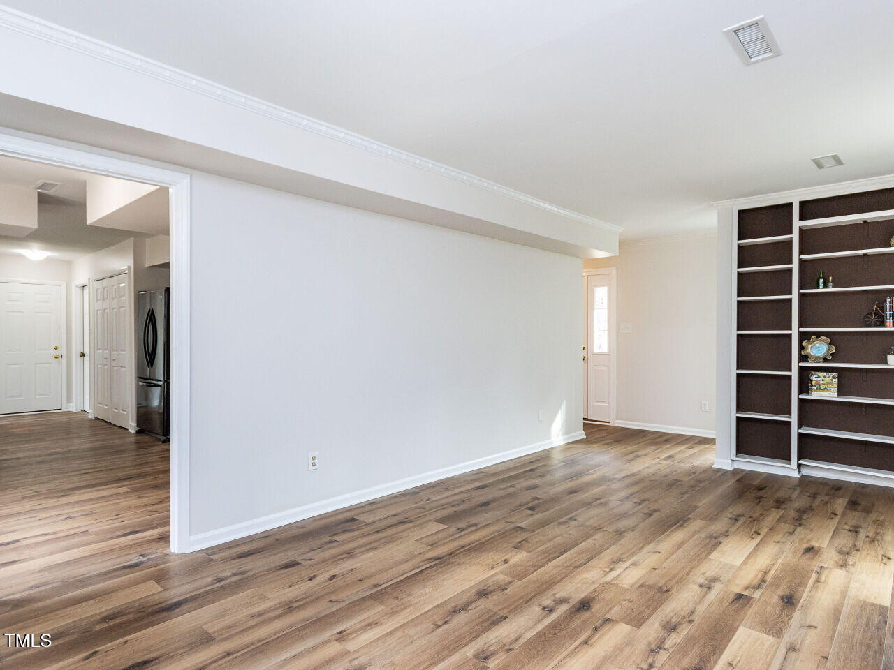7408 Stable End Road Raleigh, NC 27613 - Photo 9 of 39 a view of an empty room with wooden floor and closet