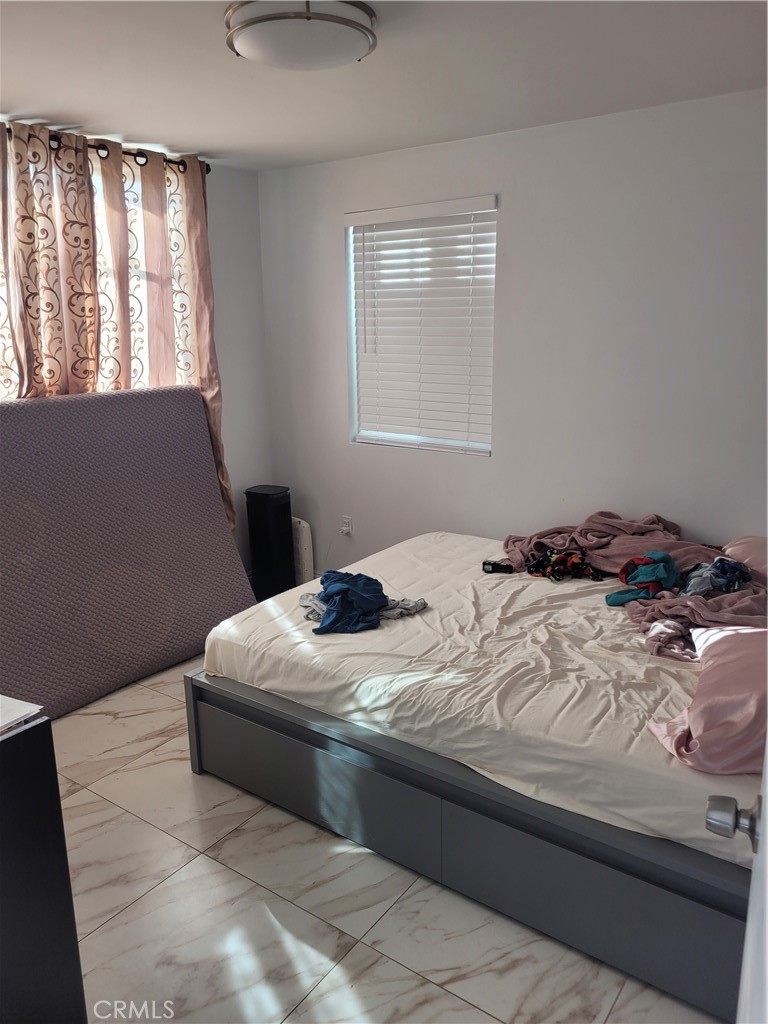 3833 1/2 Olive Street Huntington Park, CA 90255 - Photo 3 of 8 a bedroom with bed and window