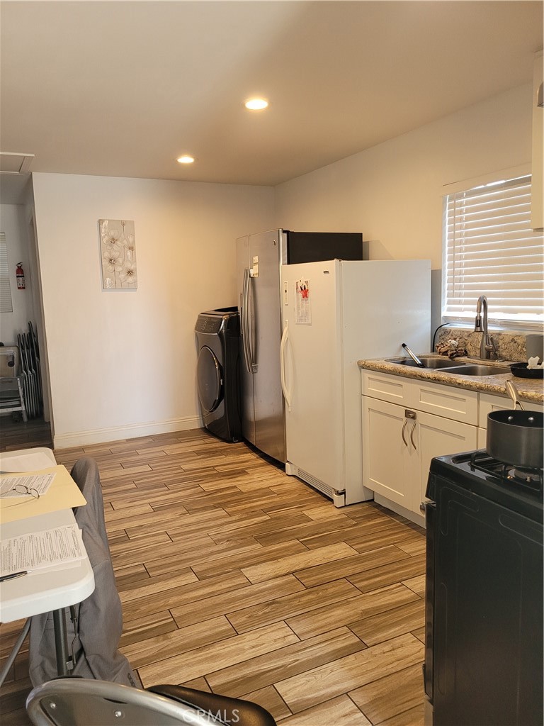 3833 1/2 Olive Street Huntington Park, CA 90255 - Photo 4 of 8 a bedroom with a bed and a refrigerator