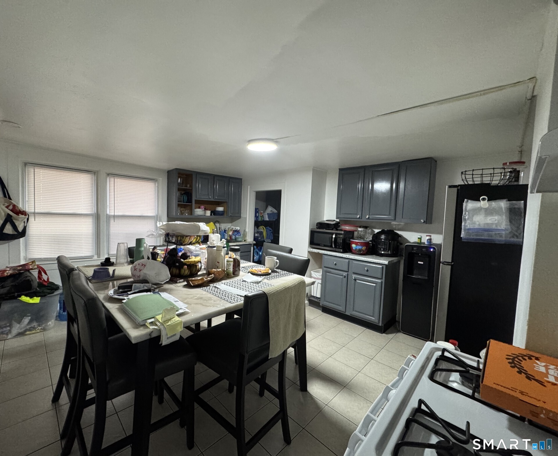 34-36 Cottage Street Manchester, CT 06040 - Photo 13 of 40 a kitchen with a dining table chairs and refrigerator