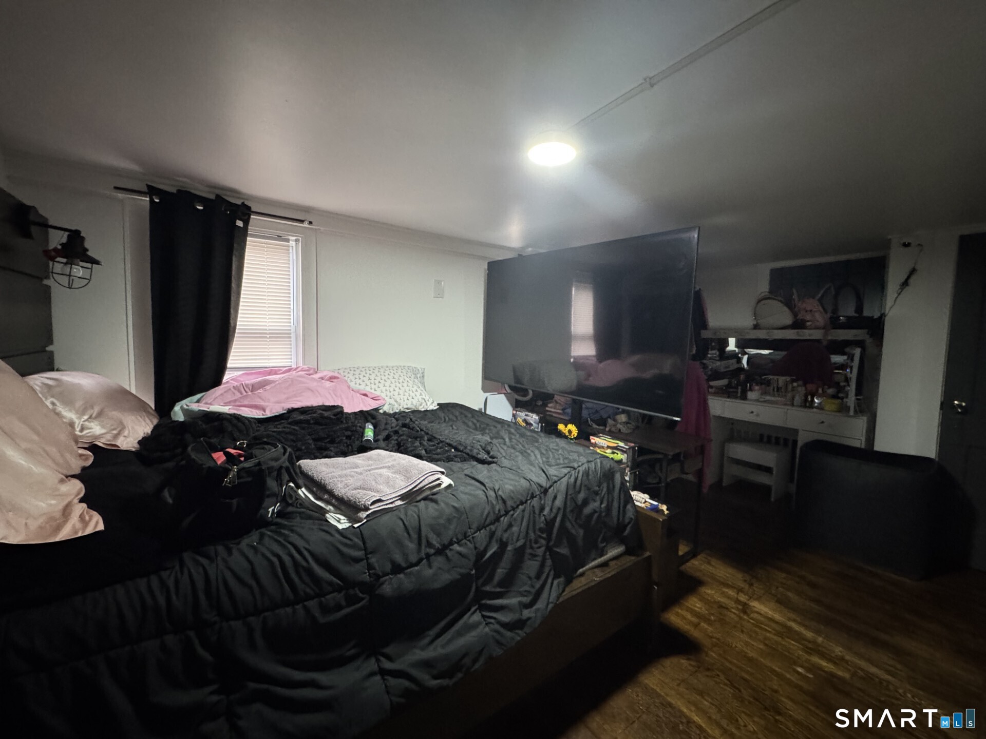 34-36 Cottage Street Manchester, CT 06040 - Photo 14 of 40 a bedroom with a bed and a television