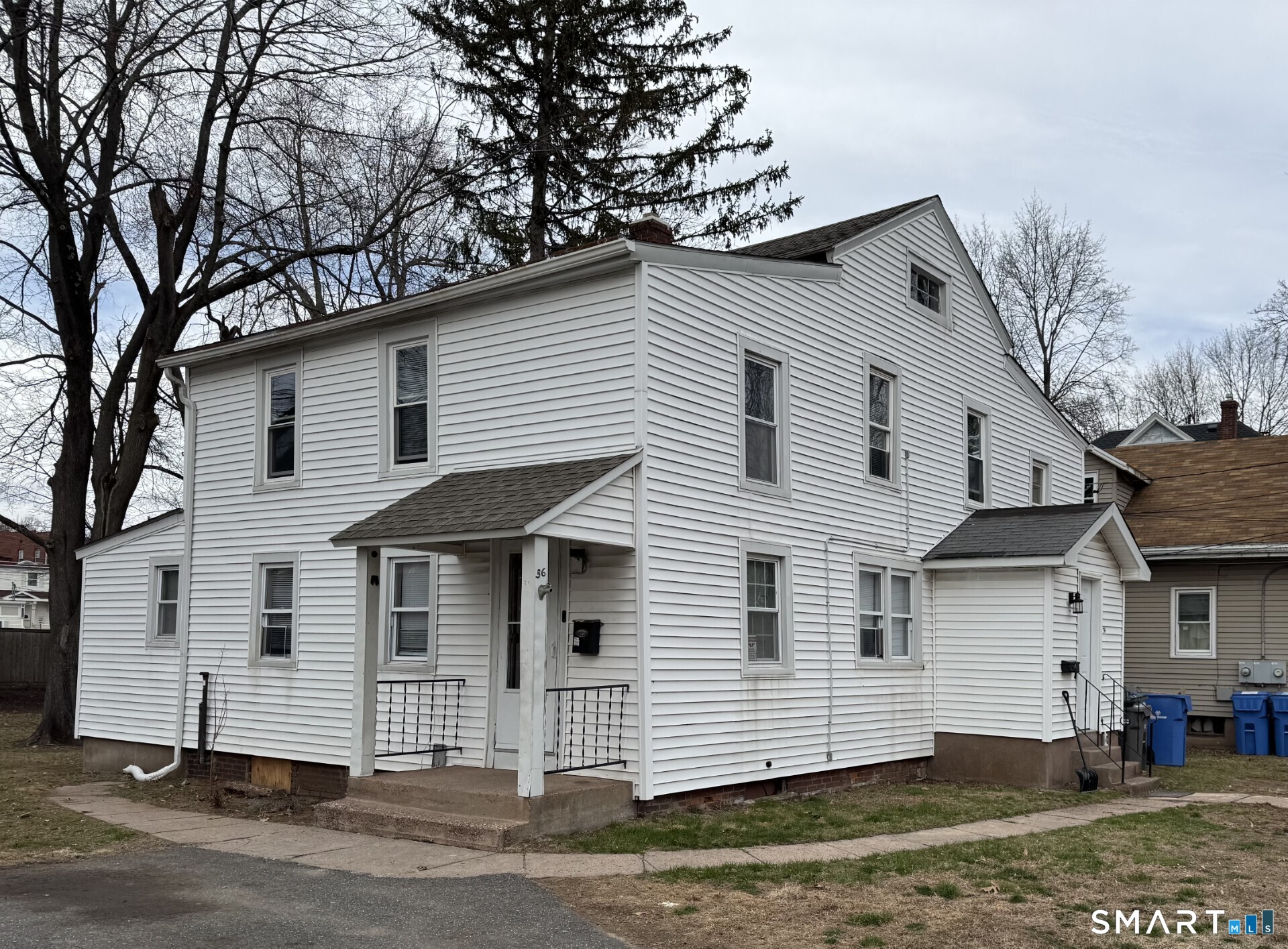 34-36 Cottage Street Manchester, CT 06040 - Photo 2 of 40 a view of a white house with a white fence