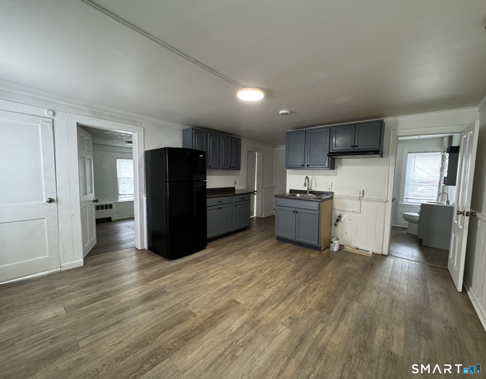 34-36 Cottage Street Manchester, CT 06040 - Photo 22 of 40 a kitchen with stainless steel appliances wooden floor and large windows