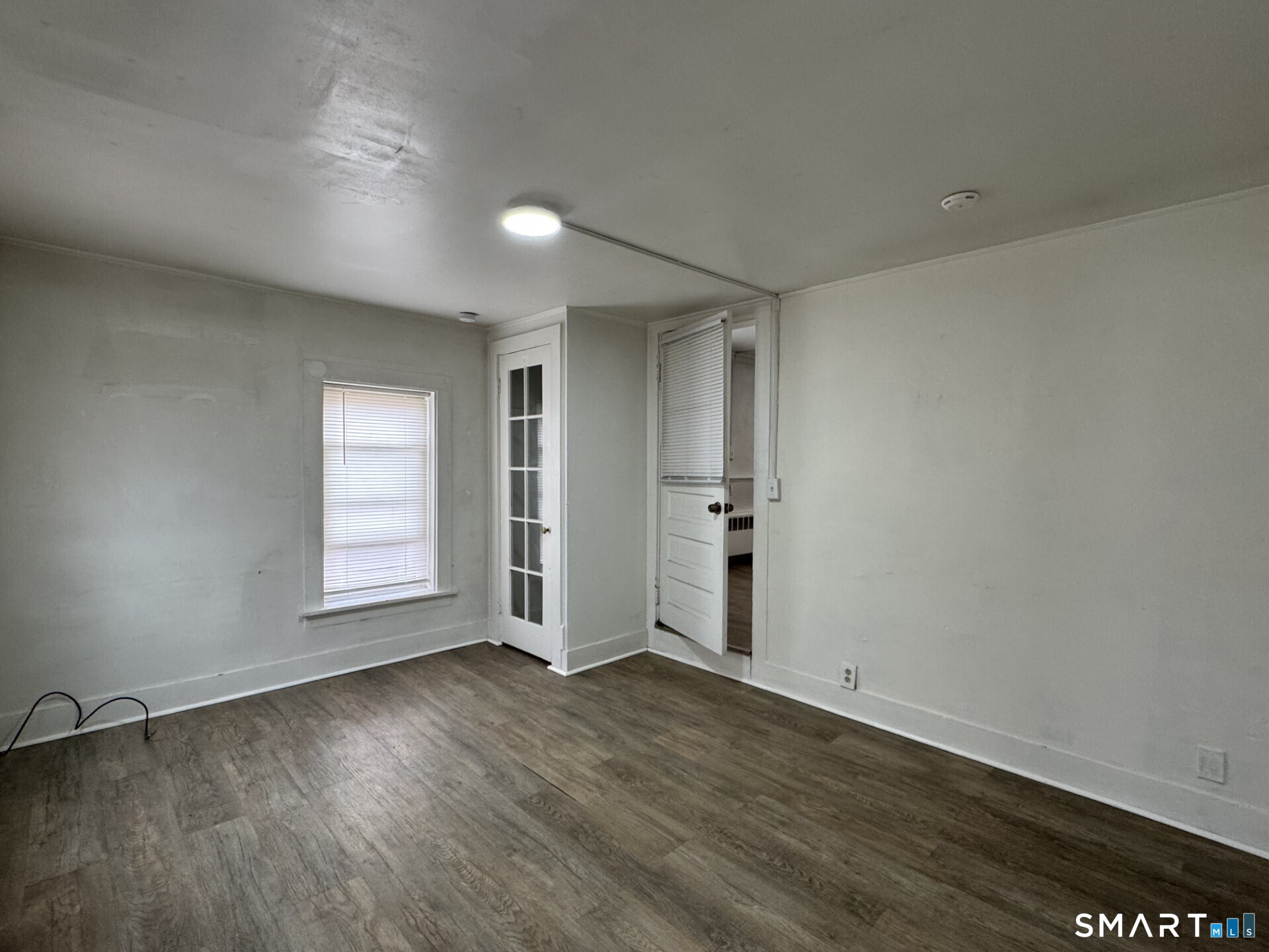 34-36 Cottage Street Manchester, CT 06040 - Photo 26 of 40 an empty room with wooden floor and windows