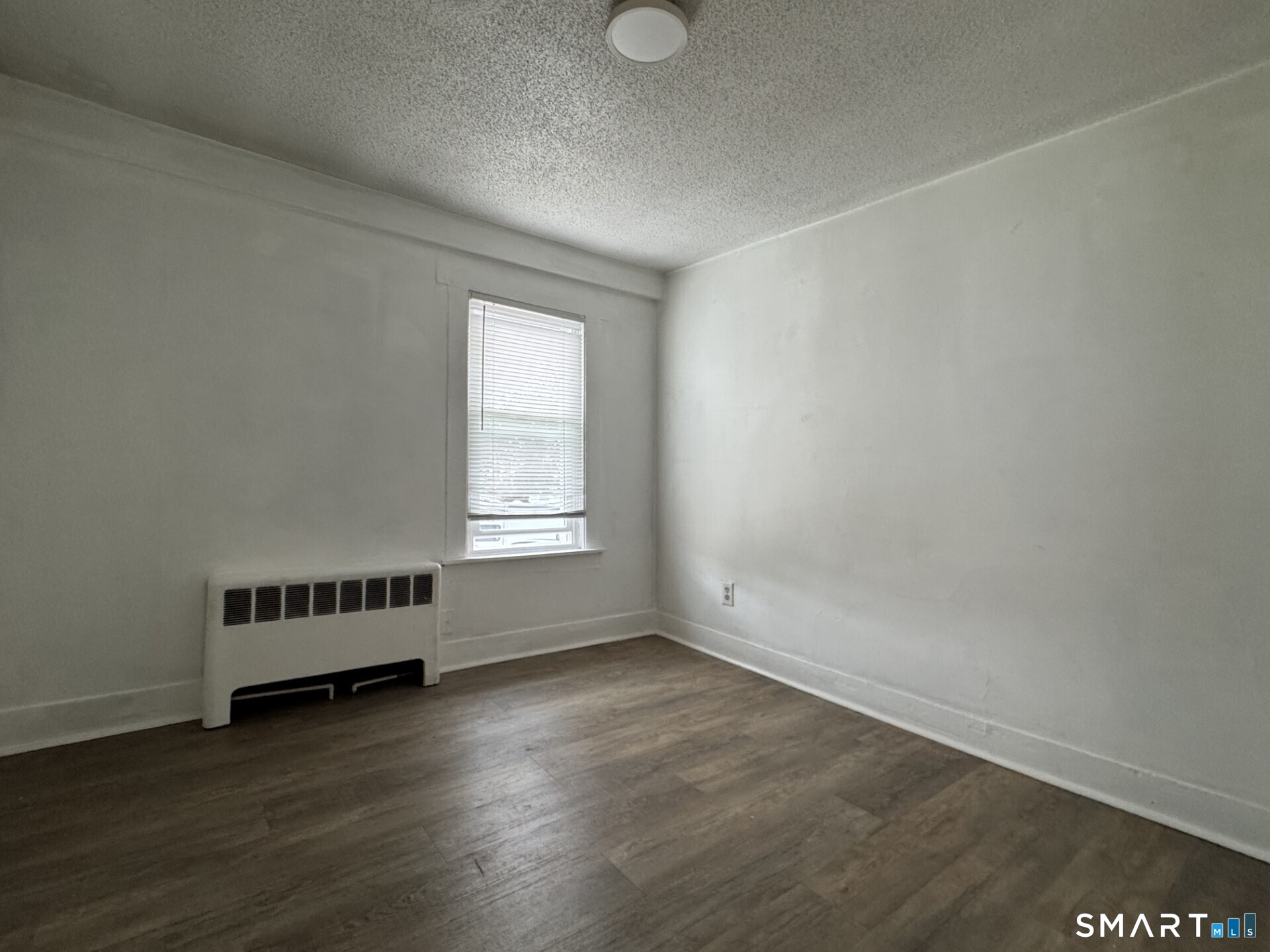 34-36 Cottage Street Manchester, CT 06040 - Photo 27 of 40 an empty room with wooden floor and windows